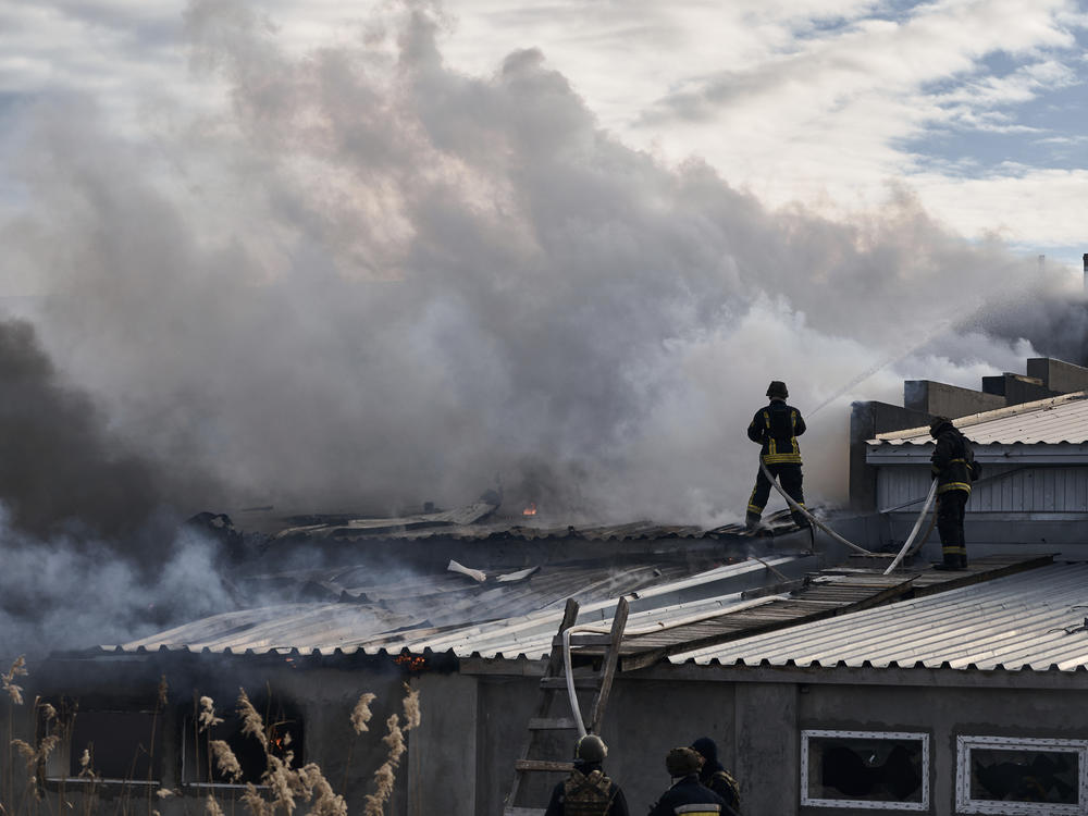 Ukrainian State Emergency Service firefighters put out a fire after Russian shelling hit an industrial area in Kherson, Ukraine, on Friday.