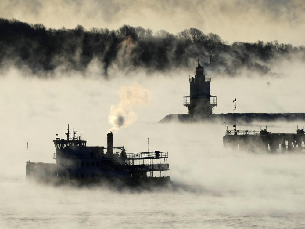Arctic sea smoke rises from the the Atlantic Ocean as a passenger ferry passes Spring Point Ledge Light, on Saturday, off the coast of South Portland, Maine. The morning temperature was about minus 10 degrees Fahrenheit.