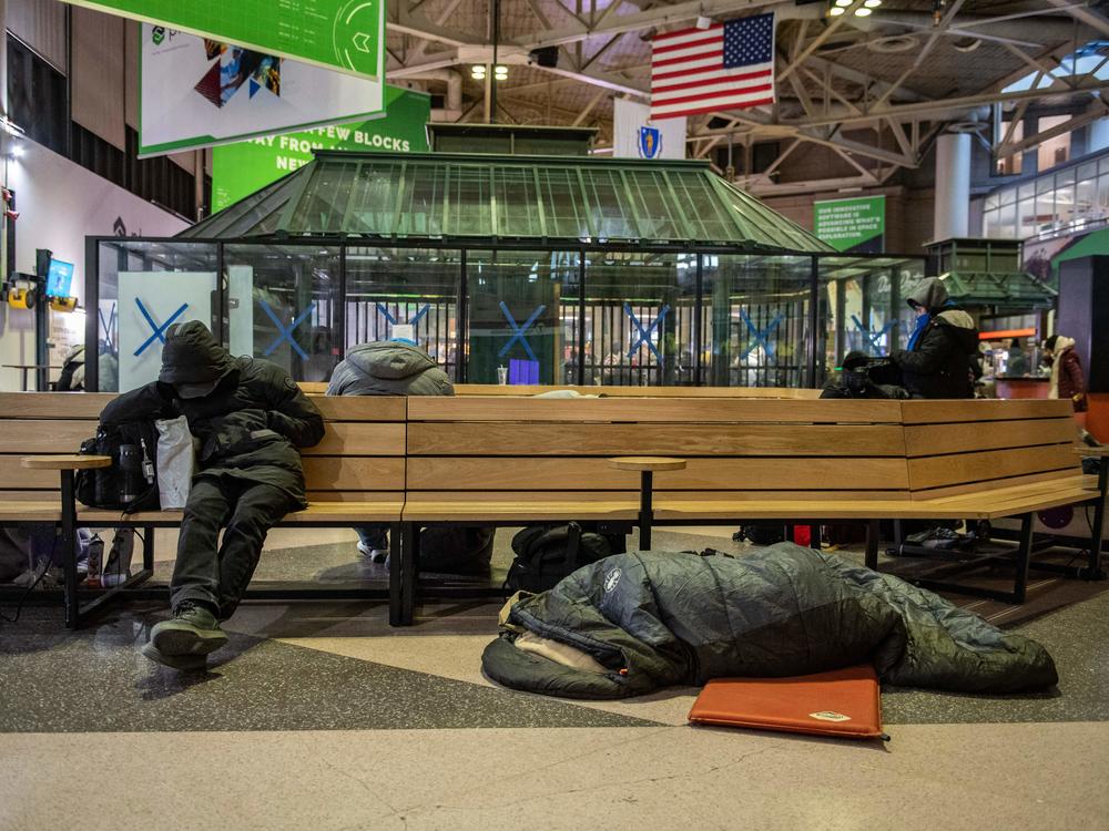 Homeless people stay warm at South Station, set up as as warming center, as temperatures reached minus 7 Fahrenheit in Boston on Saturday.