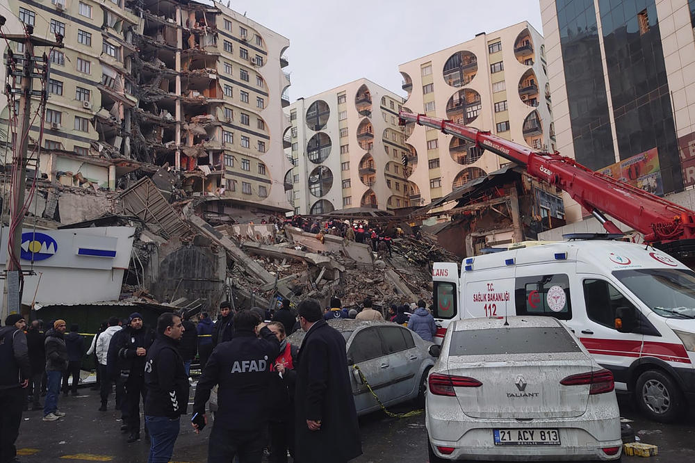Rescue workers and medical teams try to reach trapped residents in a collapsed building following an earthquake in Diyarbakir, southeastern Turkey, early Monday. A powerful earthquake has caused significant damage in southeast Turkey and Syria and many casualties have been reported.