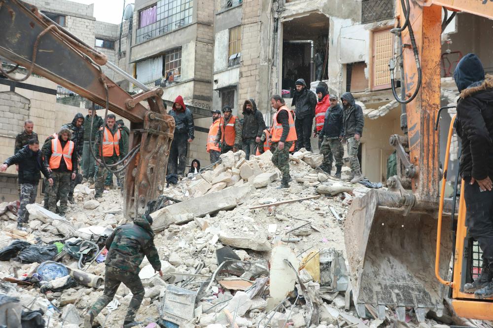 Syrian rescue teams look for survivors under the rubble after a 7.8 magnitude earthquake in the government-controlled central Syrian city of Hama on Monday. The earthquake hit Turkey and Syria killing hundreds of people as they slept, leveling buildings and sending tremors that were felt as far away as the island of Cyprus, Egypt and Iraq.