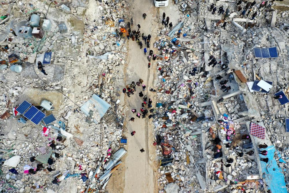 This aerial view shows residents searching for victims and survivors amidst the rubble of collapsed buildings following an earthquake in the village of Besnia near the town of Harim, in Syria's rebel-held northwestern Idlib province on the border with Turkey, on Monday.