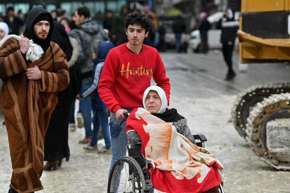 People evacuate their homes following a deadly earthquake that shook Syria at dawn in Aleppo's Salaheddine district.