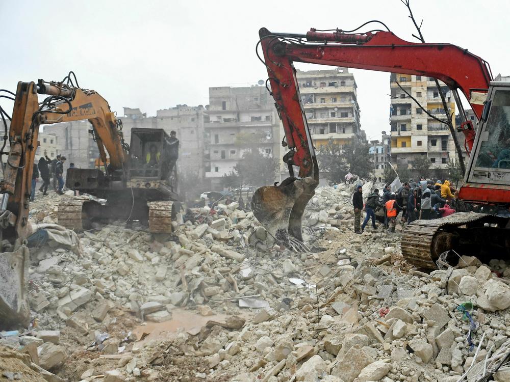 Rescuers search for victims and survivors in the rubble of a collapsed building in Aleppo, Syria, on Monday.