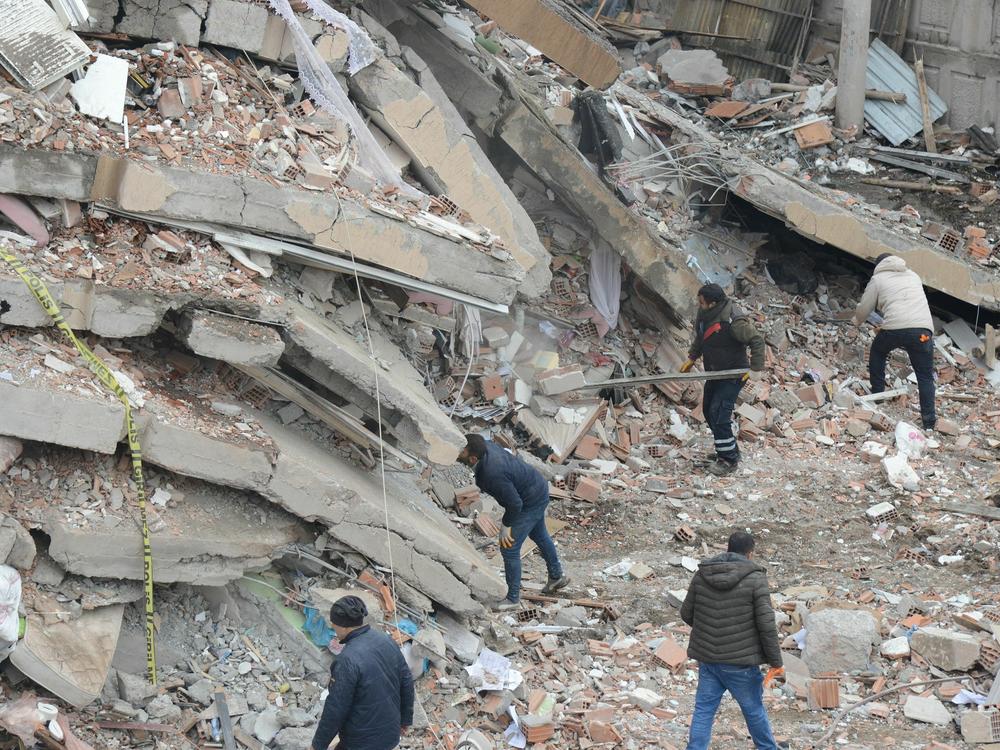 Rescue workers and volunteers conduct search and rescue operations in the rubble of a collapsed building in Diyarbakir, Turkey, after Monday's 7.8 magnitude earthquake.