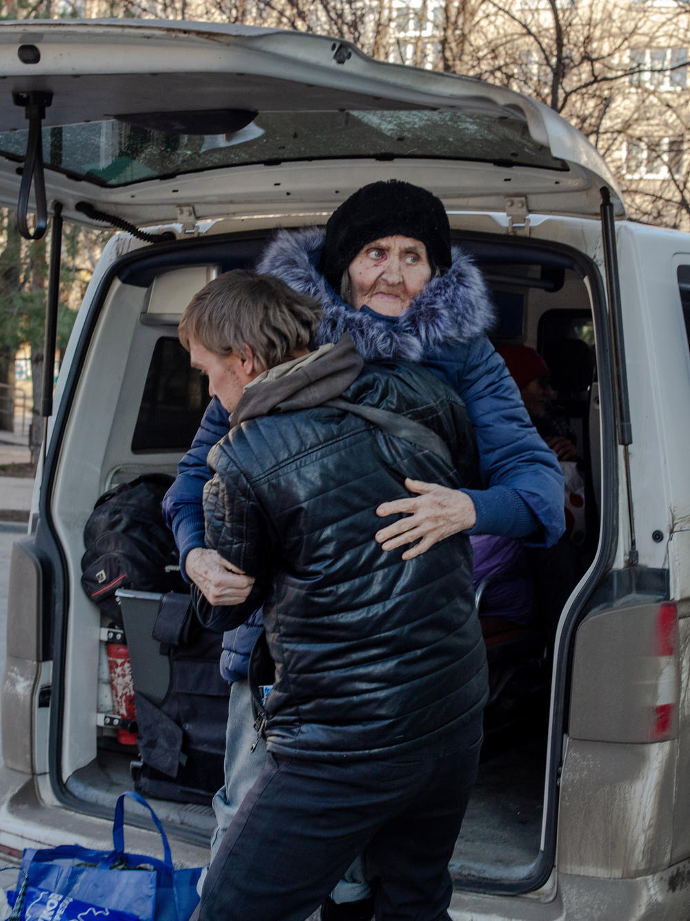 Vlad opens the van doors for two parents and their son, whom he had just evacuated. They said they had fled with the clothes on their backs when their home was blown up by a Russian rocket, and had spent three days taking cover and waiting for rescue. Mykhaylo Rvachov, the son, helped his mother, Svitlana Rvachova, get out of the van.