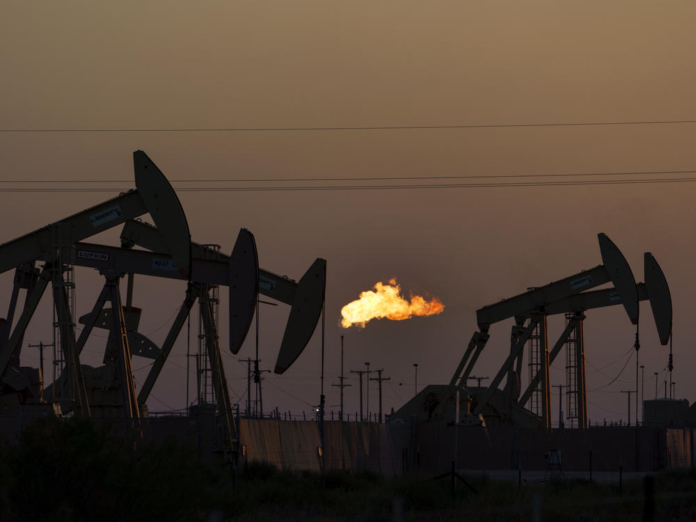 A fire burns at a fossil fuel extraction site in Texas in 2021. The Environmental Protection Agency has proposed a new way to evaluate the cost to humanity of emitting greenhouse gases.