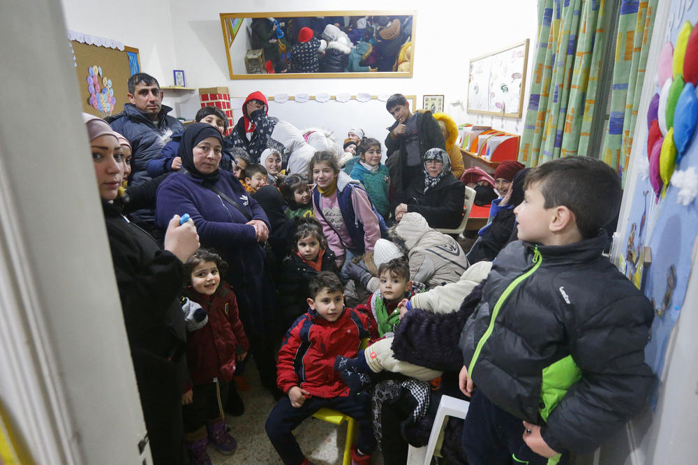 People gather at a convent to spend the night as they fear more tremors following a deadly earthquake on Monday, in Aleppo, Syria.