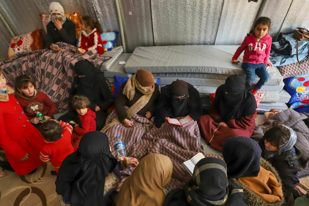 Syrian women recite prayers at an emergency shelter in the center of the city of Maarat Misrin, Syria, in the rebel-held northern part of the northwestern Idlib province one day after a deadly earthquake hit Syria and Turkey, on Tuesday.