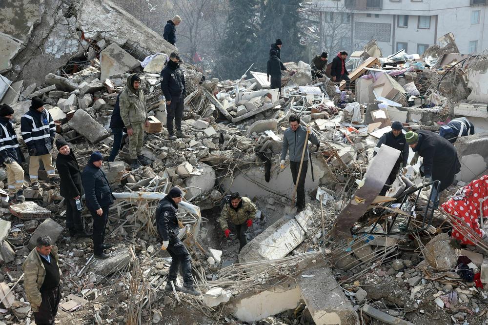 Rescuers and civilians look for survivors under the rubble of collapsed buildings in Kahramanmaras, Turkey, close to the quake's epicenter, on Tuesday.