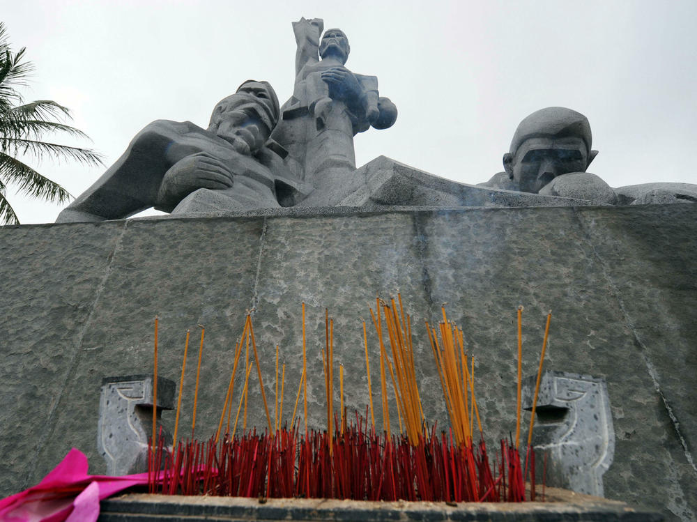 Incense sticks are placed at a monument to honor massacre victims in Vietnam.