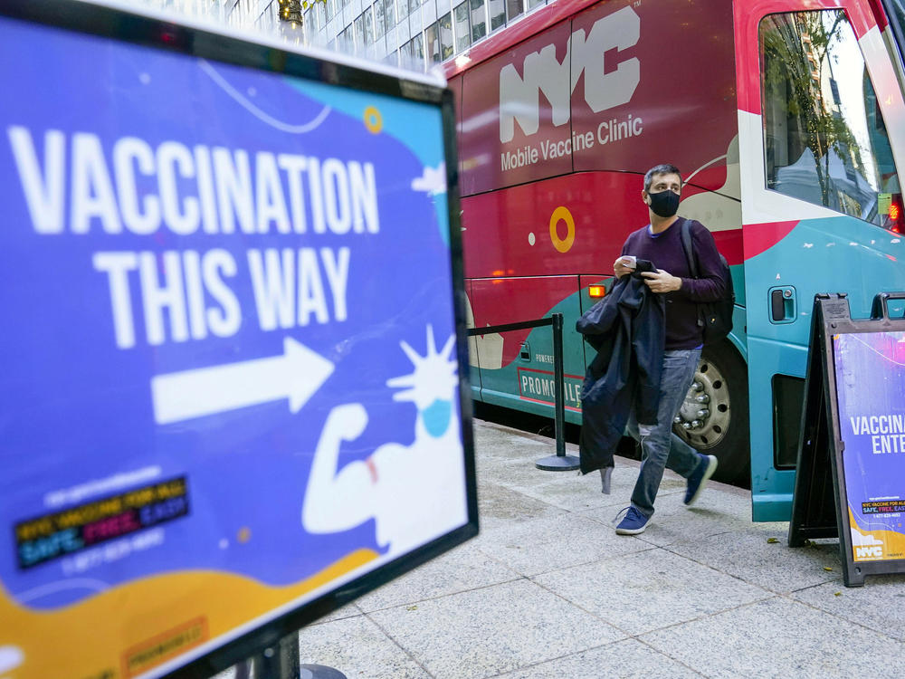 A man walks out of a vaccination bus at a mobile vaccine clinic in Midtown Manhattan, Dec. 6, 2021. New York City is ending its COVID-19 vaccination mandate for municipal employees, Mayor Eric Adams announced Monday, Feb. 6, 2023. The vaccine mandate, which led to the firing of hundreds of city workers who declined to get the shots, will end on Friday, Adams said in a news release.
