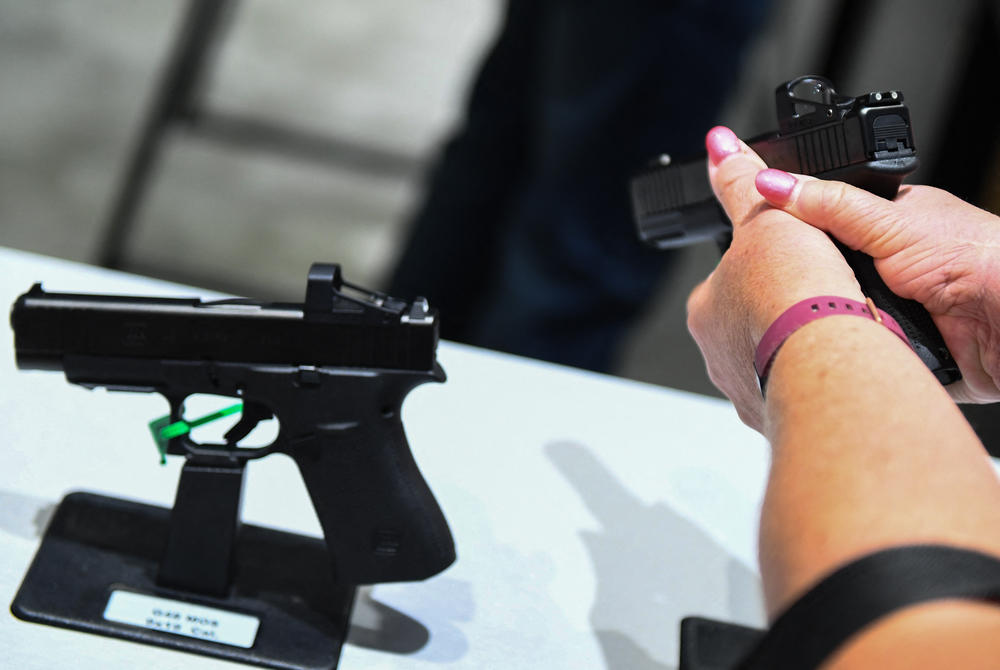 An attendee holds a Glock Ges.m.b.H. GLOCK 19 Gen5 9mm pistol during the National Rifle Association Annual Meeting at the George R. Brown Convention Center, in Houston, Texas on May 28, 2022.