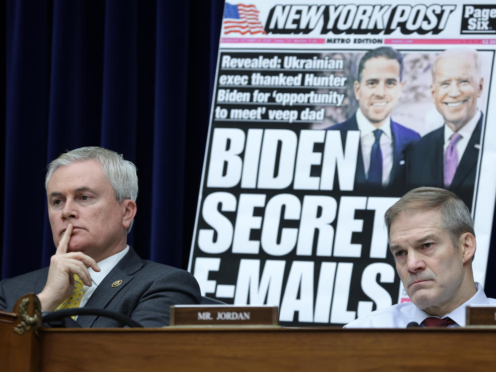 With a poster of a <em>New York Post</em> front page story about Hunter Biden's emails on display, Rep. James Comer, R-Ky., and Rep. Jim Jordan, R-Ohio, listen during a hearing before the House Oversight and Accountability Committee on Wednesday. The committee held a hearing on Twitter's short-lived decision to limit circulation of the <em>Post </em>story in 2020.