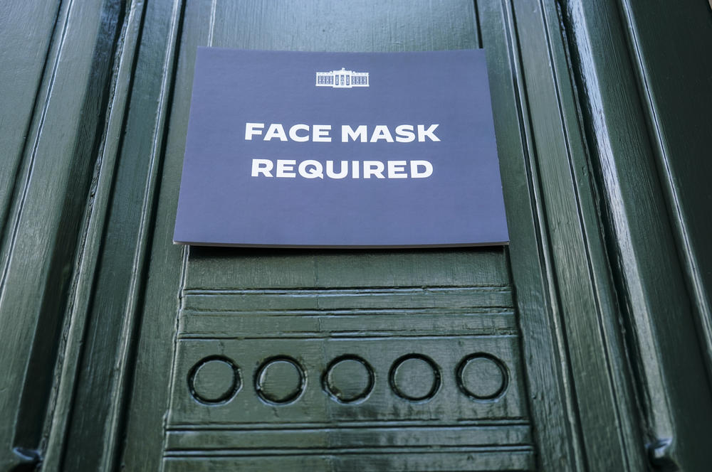A sign requiring the wearing of face masks is displayed at the testing center for visitors to the White House on July 30, 2022 in Washington, DC.