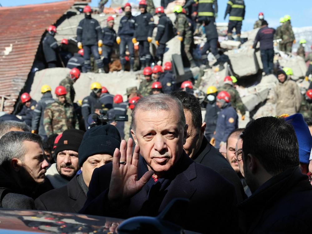 Turkish President Recep Tayyip Erdogan tours the site of destroyed buildings during his visit to the city of Kahramanmaras, in southeast Turkey, on Wednesday, two days after the severe earthquake that hit the region.