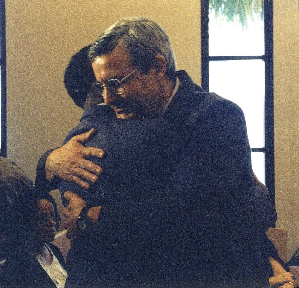 Craig Woodson hugs Edgar Woodson at the Woodson reconciliation ceremony in 1998.