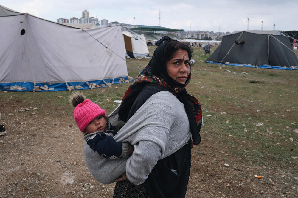 A mother, Zehra Cati, with her young child at a makeshift camp for people displaced by the earthquake.