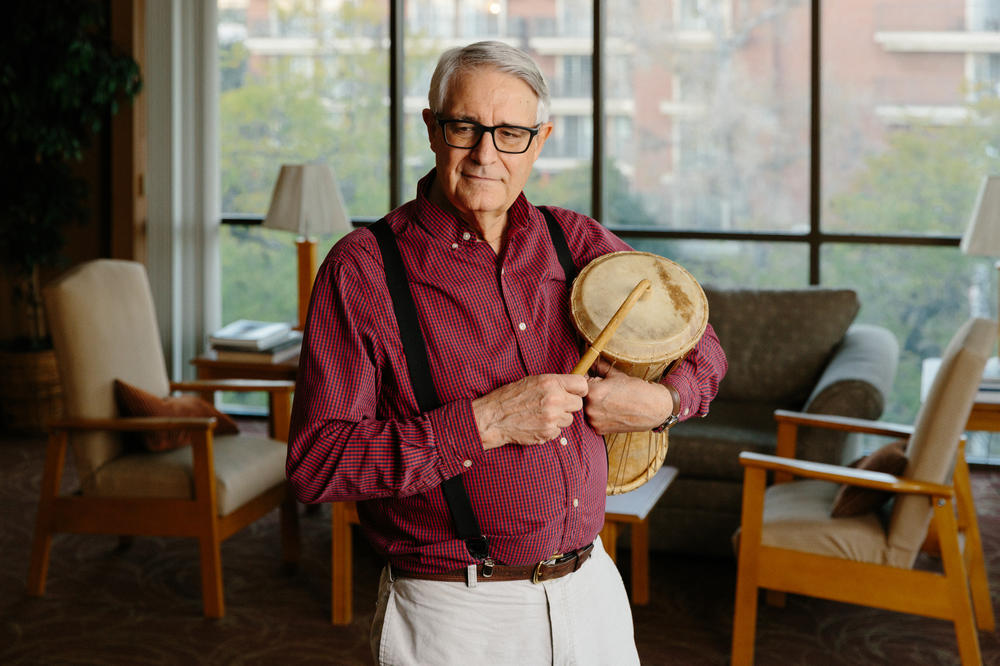 Craig Woodson, an ethnomusicologist who specializes in African drumming, holds an African talking drum.