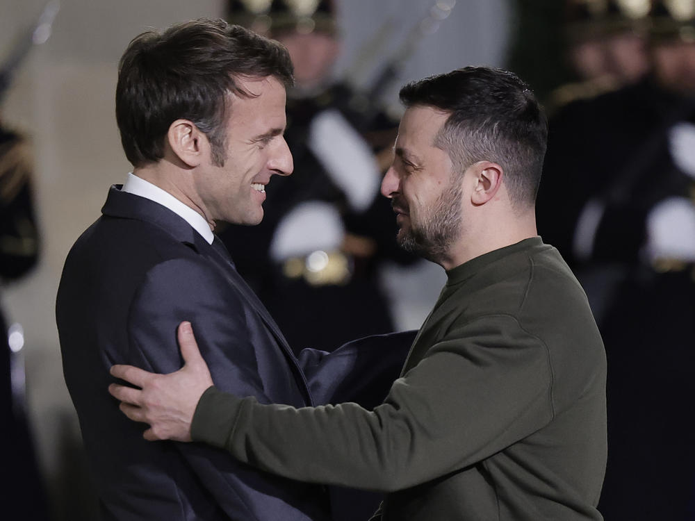 French President Emmanuel Macron, left, welcomes Ukrainian President Volodymyr Zelenskyy at the Elysee Palace before a working diner with German Chancellor Olaf Scholz, Wednesday, Feb. 8, 2023 in Paris.