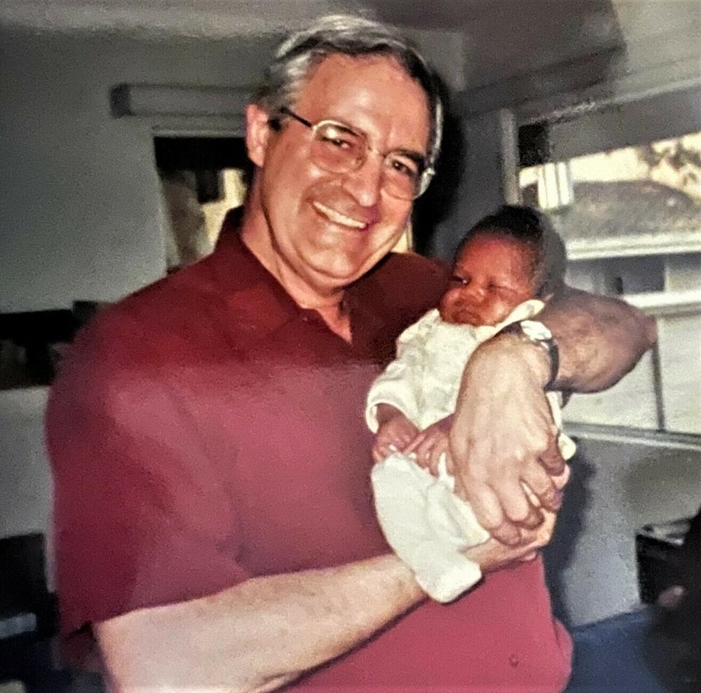 Craig Woodson holding Brett Woodson Bailey as a baby.