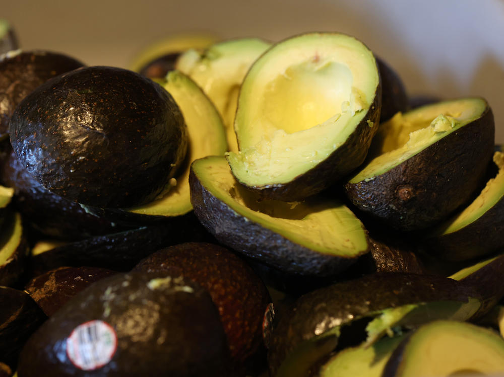 Fresh avocados sit in a bowl while guacamole is prepared at a restaurant in San Franscisco on Feb. 9, 2022. Avocado prices have dropped 23% since last year's Super Bowl.