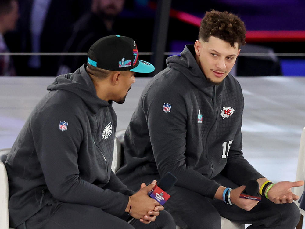 Jalen Hurts (left) of the Philadelphia Eagles talks with Patrick Mahomes  of the Kansas City Chiefs during Super Bowl LVII Opening Night at Footprint Center on Monday in Phoenix.