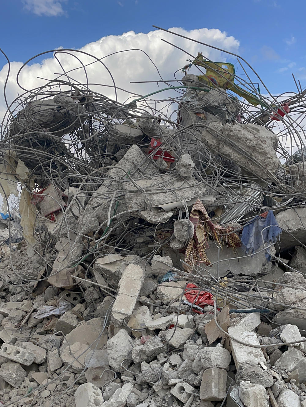 Personal possessions are seen on Friday in Jinderis, Syria, amid the tangle of rubble of a destroyed building.