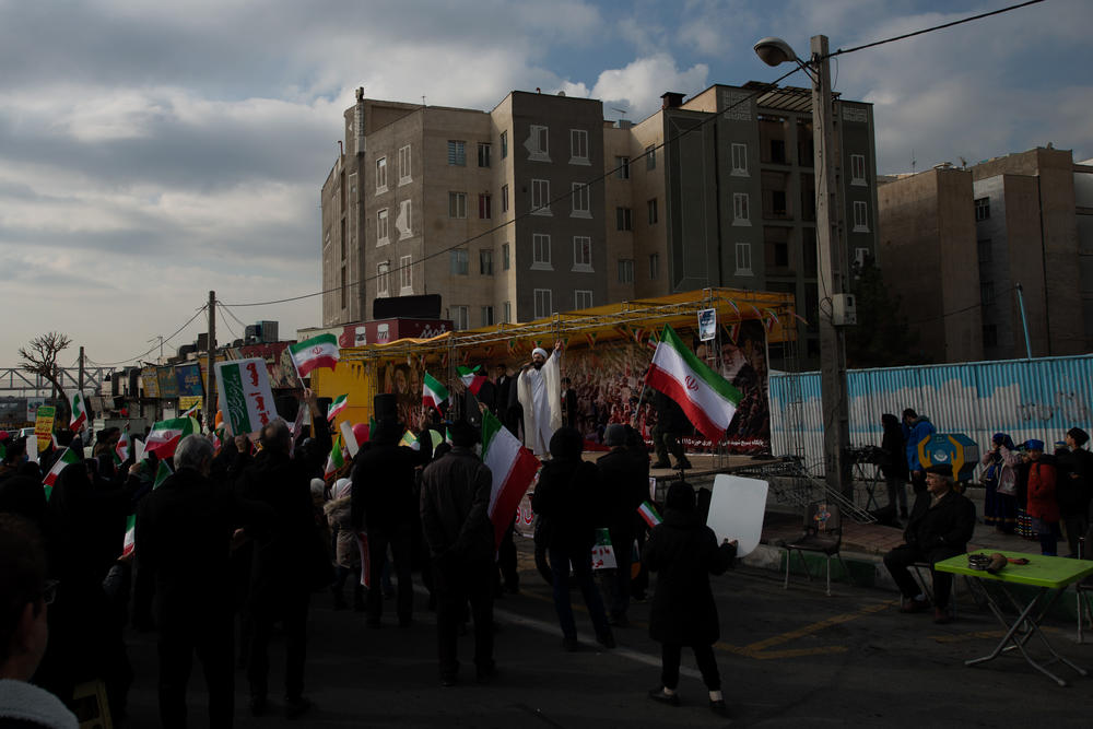 Iranian clergy encourage the crowd to join them in singing a political song popular with conservatives in the country.