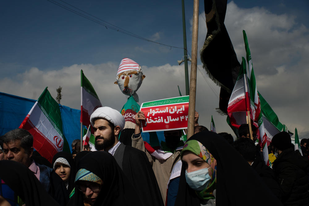 Parade goers display a pro-government sign written in Farsi.