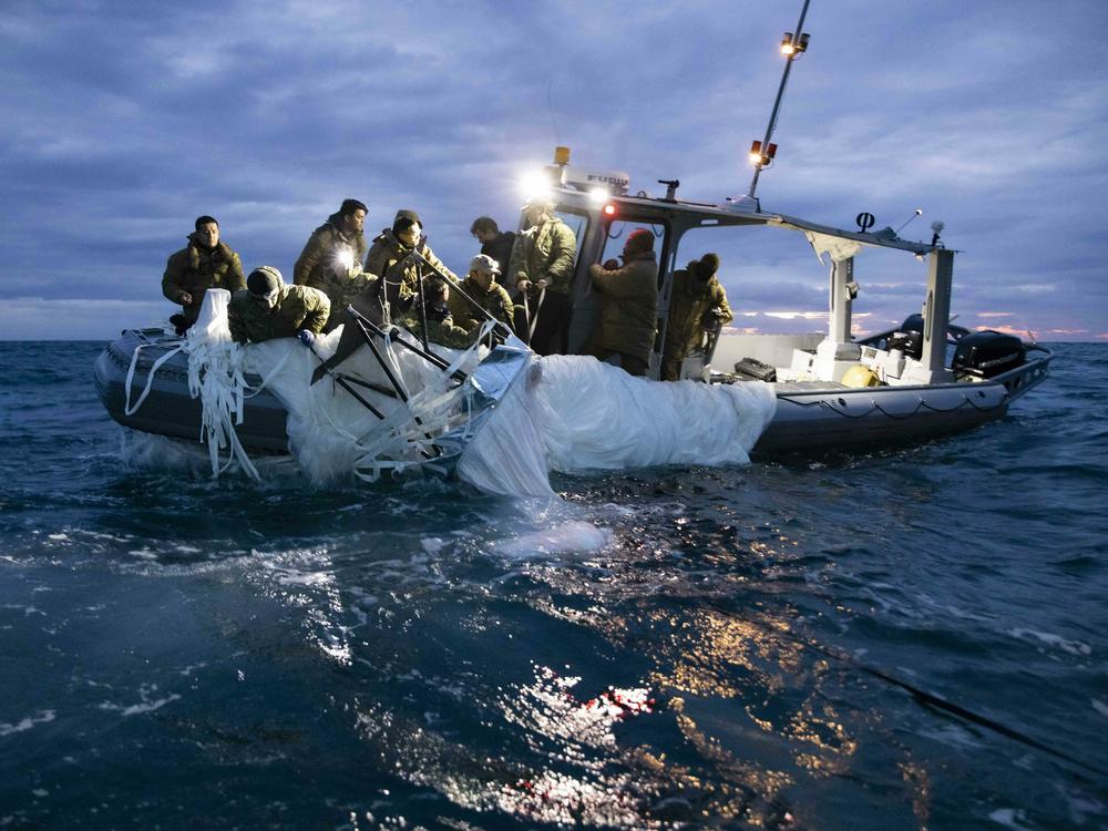 Sailors recover a high-altitude surveillance balloon in the waters off the coast of Myrtle Beach, S.C., on Feb. 5, after a fighter jet shot the balloon out of the sky.