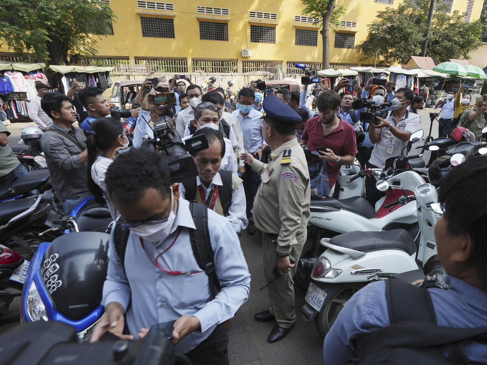 Authorities arrive at the Voice of Democracy office in Phnom Penh, Cambodia on Monday, Feb. 13.