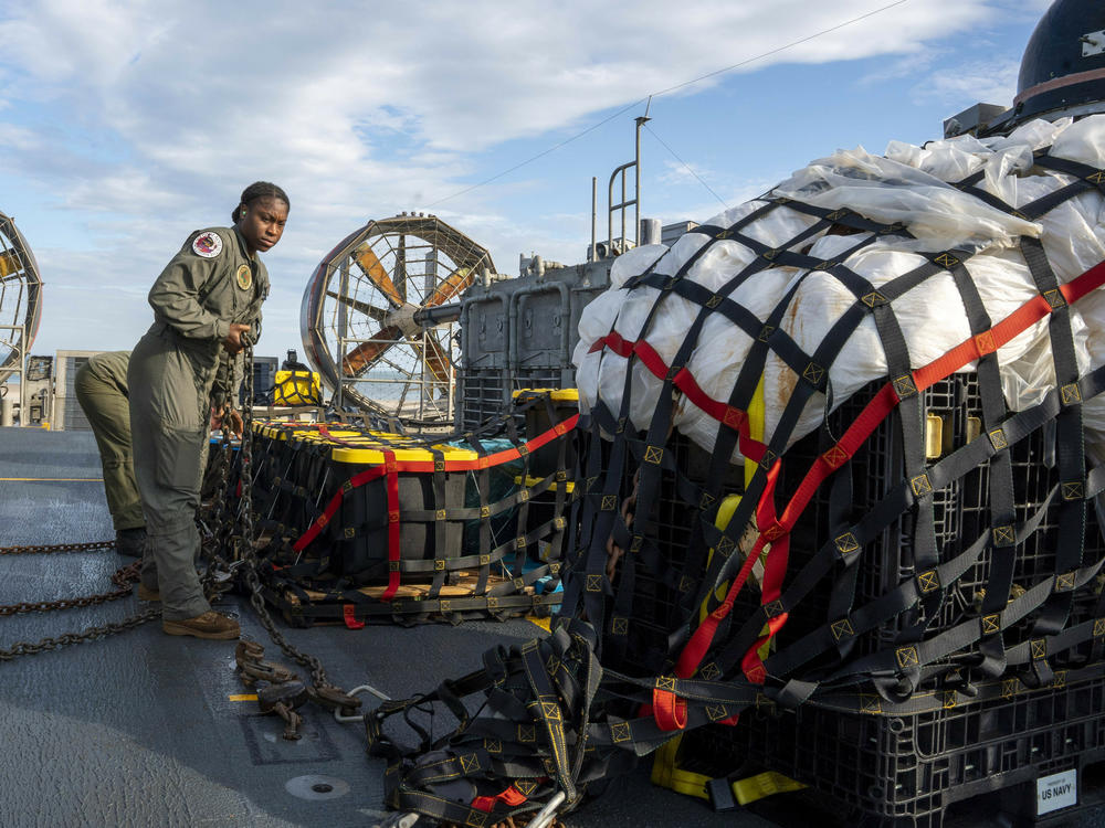 Sailors prepare material recovered in the Atlantic Ocean from a high-altitude balloon Friday for transport. The U.S. military says it has succeeded in recovering 