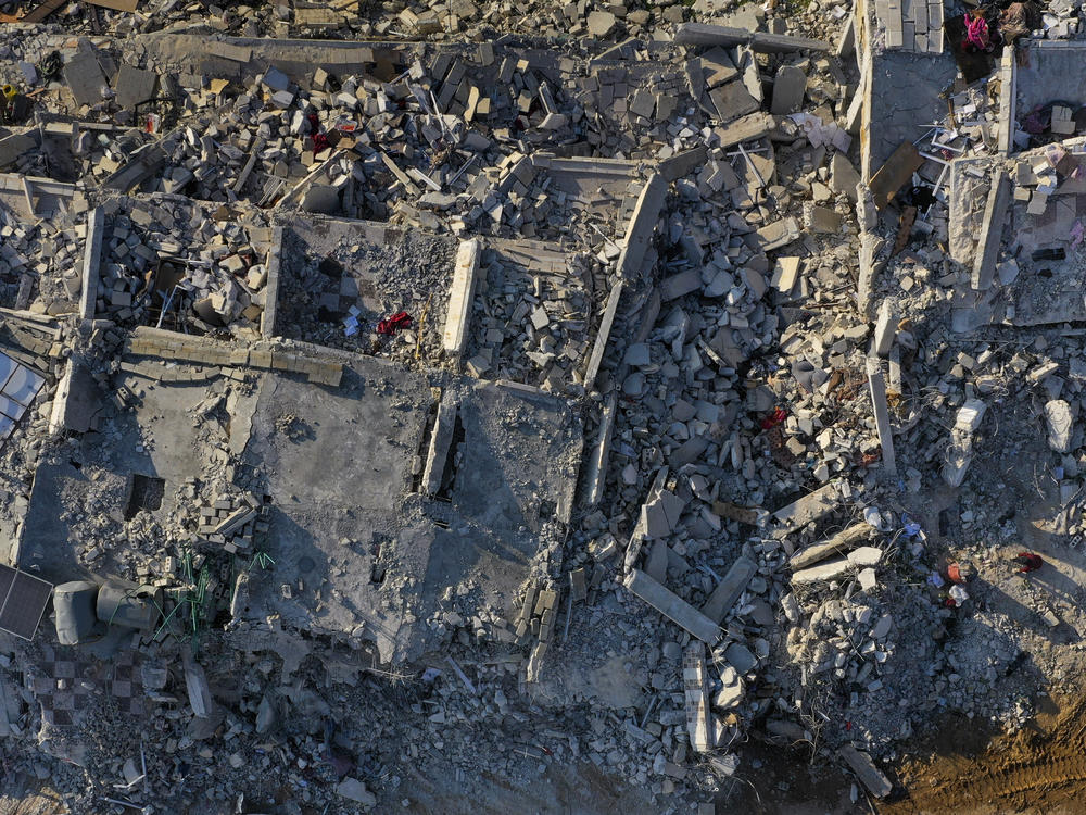 Rescue workers continue to clear rubble from collapsed houses in Sarmada, Syria, on the border crossing with Turkey, on Sunday.