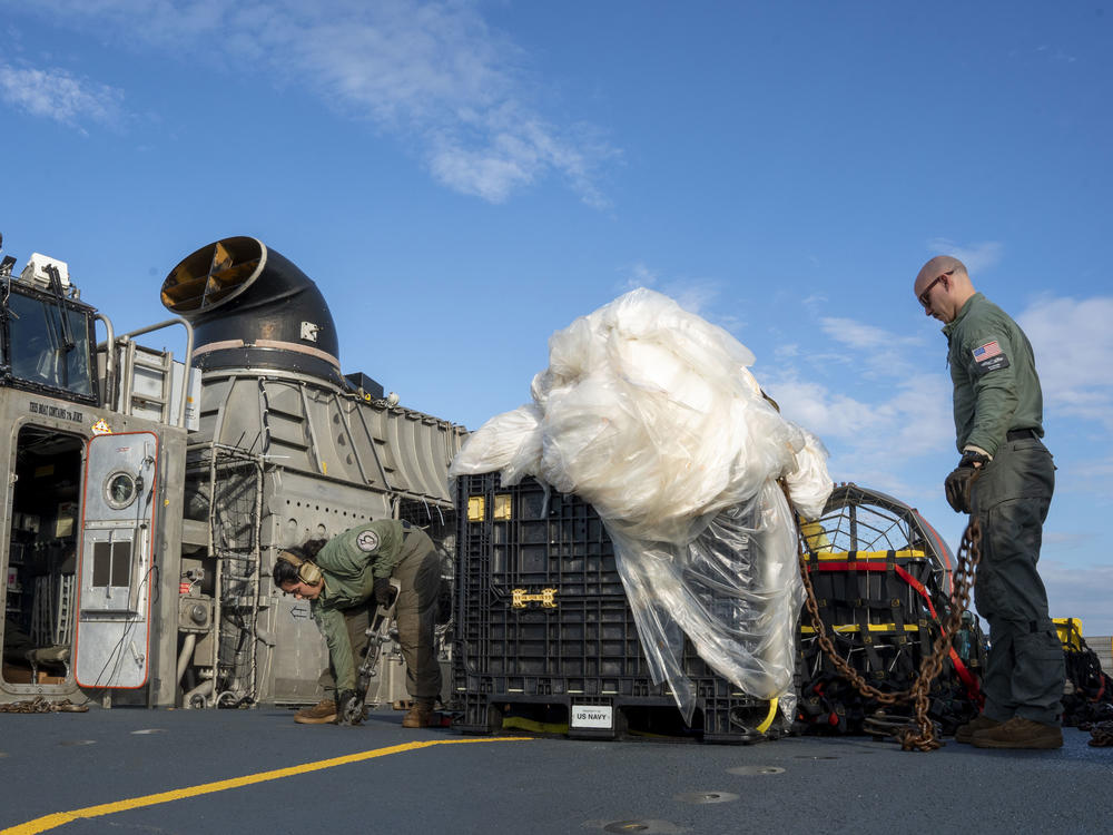 In this image released by the U.S. Navy, sailors assigned to Assault Craft Unit 4 prepare material recovered off the coast of Myrtle Beach, S.C., in the Atlantic Ocean from the shooting down of a Chinese high-altitude balloon, for transport to the FBI, at Joint Expeditionary Base Little Creek in Virginia Beach, Va., on Feb. 10.