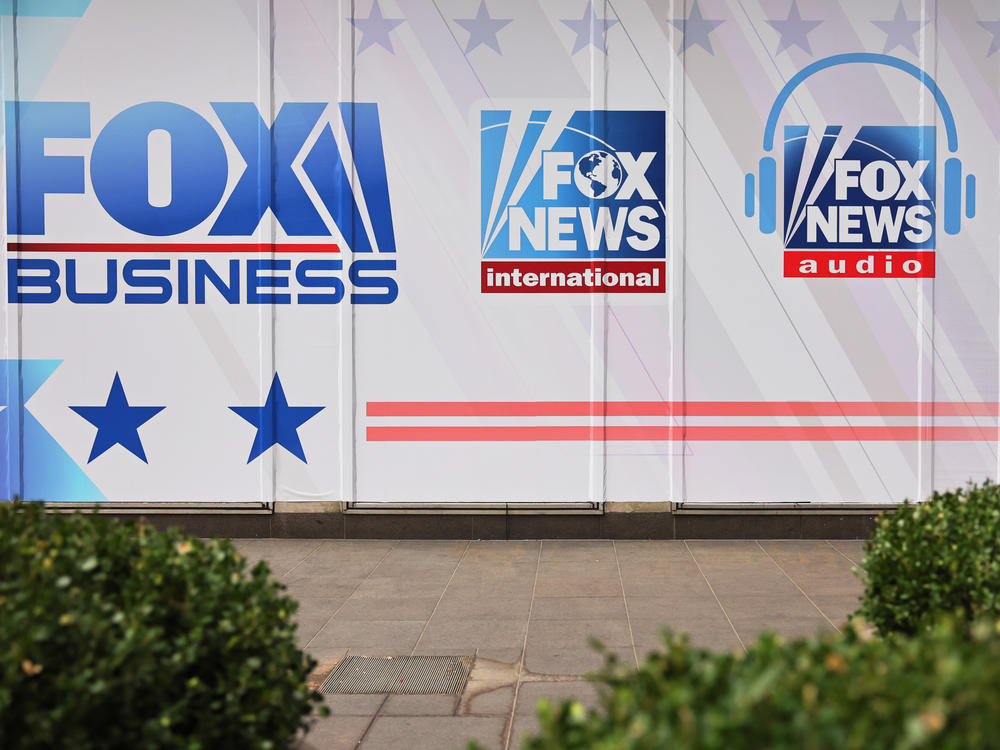 Fox News and its parent company are being sued for defamation over false claims of election fraud following the 2020 election. Above, logos for Fox News Media's growing portfolio of brands adorn its corporate headquarters in New York City.