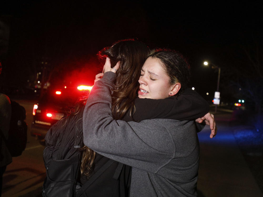 Michigan State University students hug on Monday evening, after eight students were shot on campus.