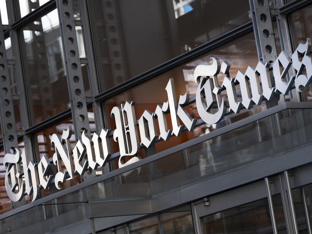 A sign for The New York Times hangs above the entrance to its building on May 6, 2021 in New York.