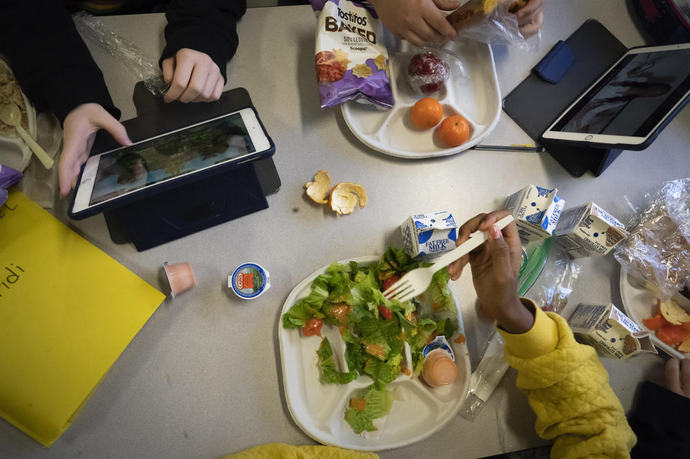 Seventh graders sit together in the cafeteria during their lunch break at a public school on Feb. 10 in the Brooklyn borough of New York.