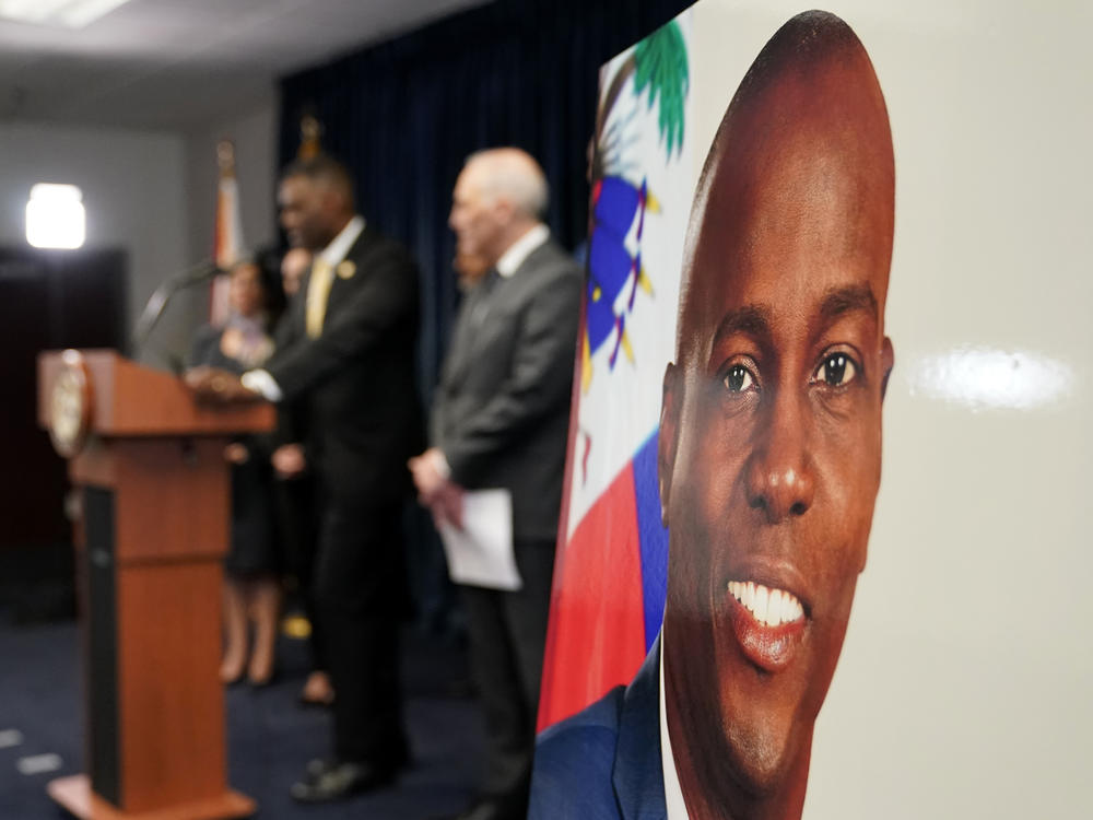 An image of Haitian President Jovenel Moïse, right, is displayed as Markenzy Lapointe, U.S. Attorney for the Southern District of Florida, speaks speaks during a news conference, Tuesday, Feb. 14, 2023, in Miami.