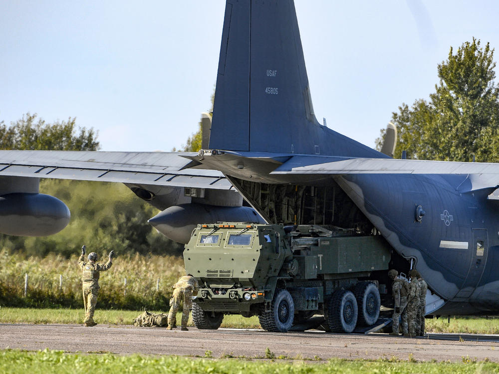 Soldiers unload a High-Mobility Artillery Rocket System (HIMARS) in Riga, Latvia, on Sept. 26, 2022. The U.S. provided Ukrainian forces with 38 HIMARS in 2022.