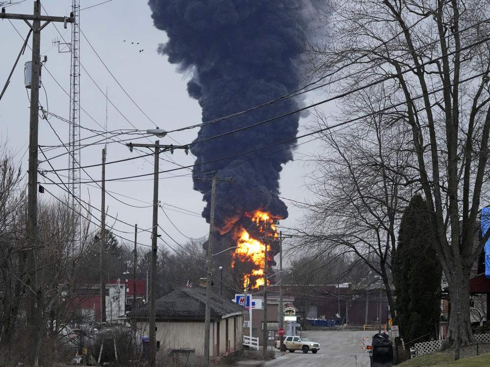 A black plume rises over East Palestine, Ohio, as a result of a controlled detonation of a portion of the derailed Norfolk Southern Monday, Feb. 6, 2023.