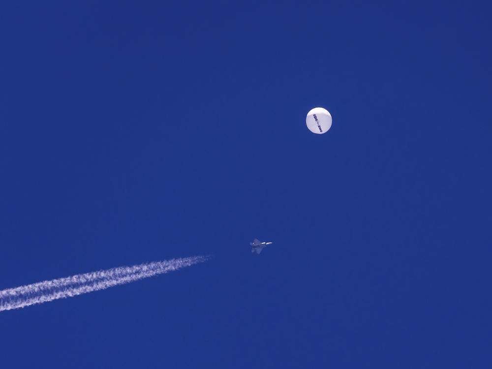A U.S. fighter jet flies near China's spy balloon just minutes before it was shot down over the Atlantic Ocean.