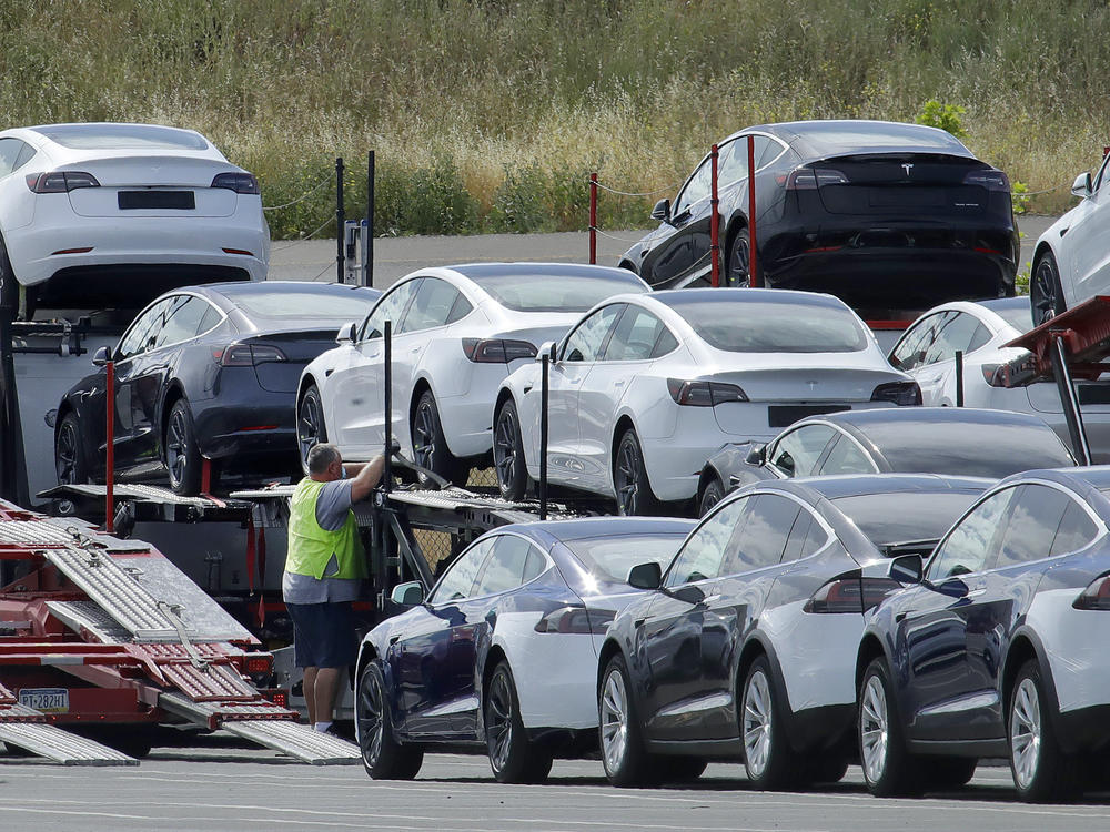 Tesla cars are loaded onto carriers at the automaker's plant in Fremont, Calif., on May 13, 2020. The company is recalling nearly 363,000 vehicles with its 