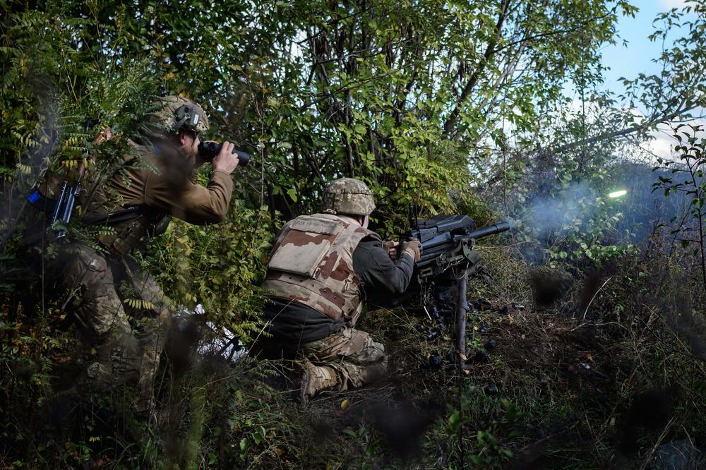 A Ukrainian soldier fires a U.S.-made MK-19 automatic grenade launcher towards Russian positions in the Donetsk region of Ukraine on Oct. 12, 2022.