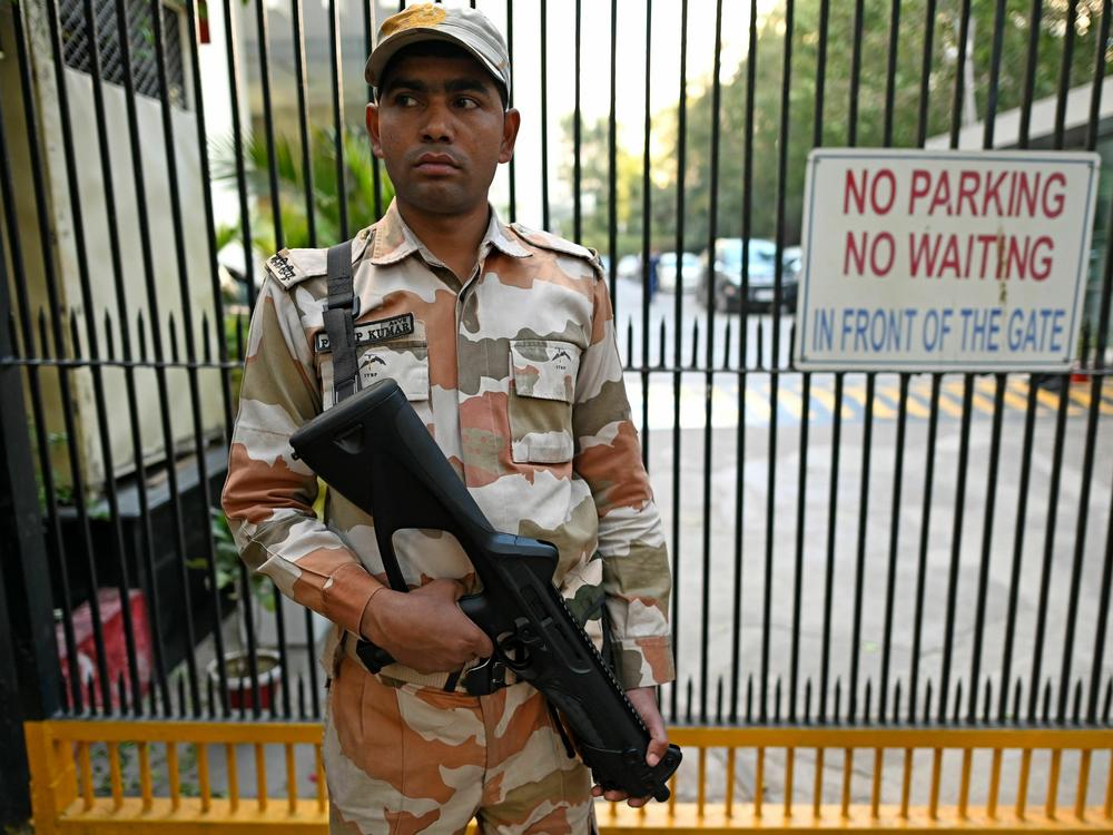 A Border Police officer stands guard outside the office building where Indian tax authorities raided BBC's office in New Delhi.