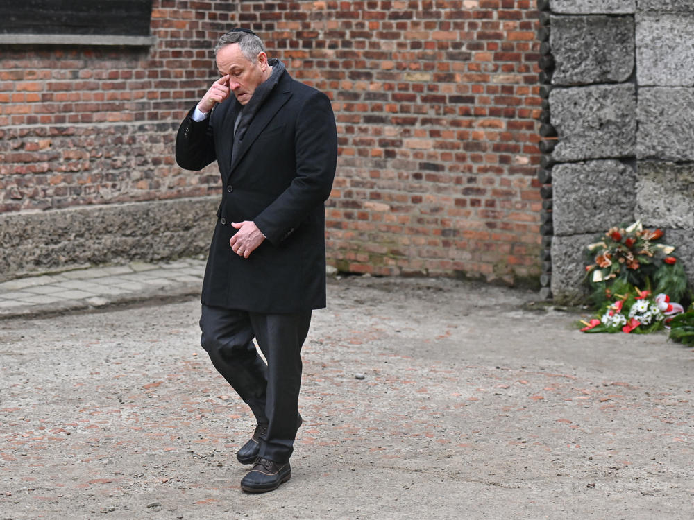 Emhoff reacts after laying wreaths honoring Holocaust victims at the former Auschwitz I site on January 27, 2023 in Oswiecim, Poland.