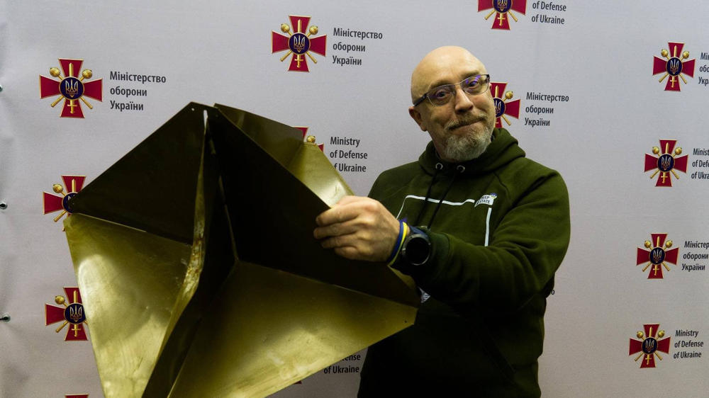 Ukraine's Defense Minister, Oleksii Reznikov, poses with a reflector similar to the one the air force says it shot down from the balloons.