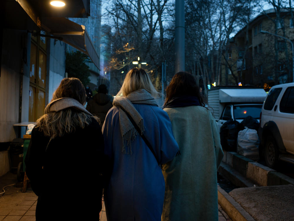 Women without headscarves stroll through Tehran's Tajrish Square in February 2023.