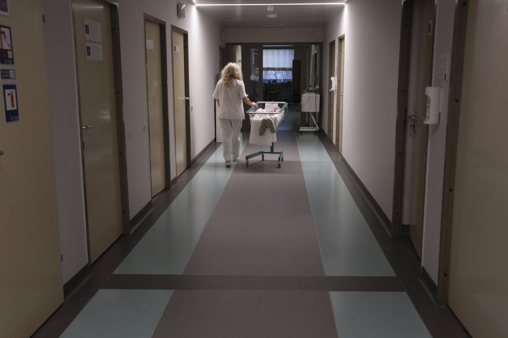 A doctor pushes a baby cart down the hallway in a maternity hospital in Kyiv.